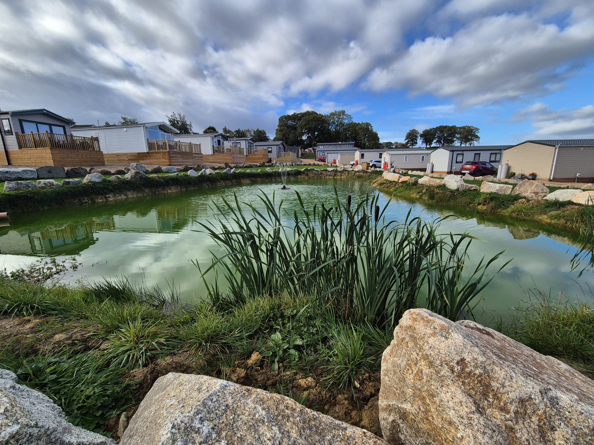 Site image closer shot of pond with caravans in background2